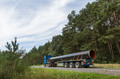 Pipe delivery: a truck brings a pipe to a nearby storage point.