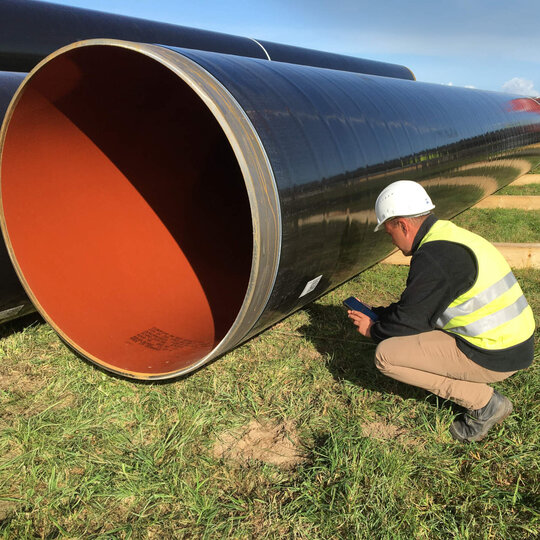 Employee scanning QR code of a pipe