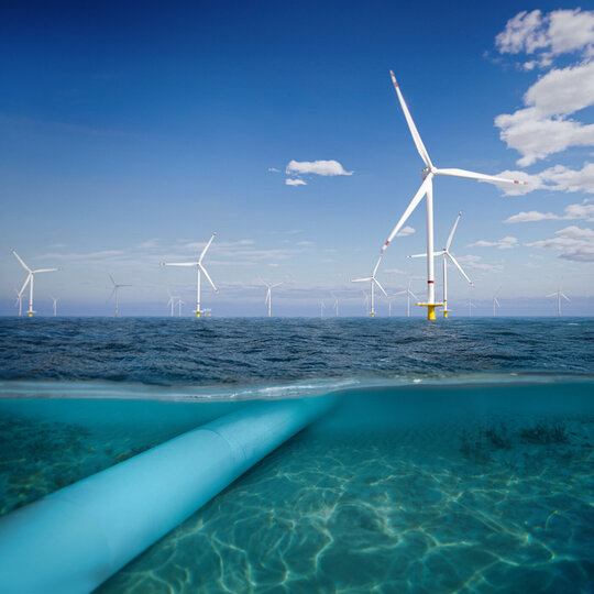 Unterwasser-Pipeline mit Windpark über der Meeresoberfläche